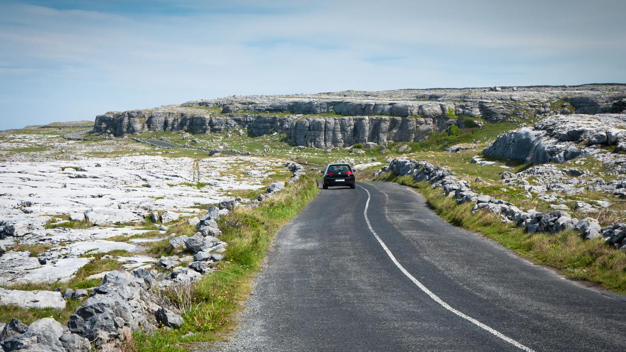 Car touring though Rocky Landscape of the Burren, County Clare, on the West Coast of Ireland