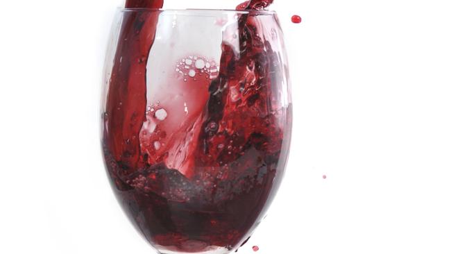 red wine flowing in transparent glass