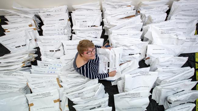 SWAMPED: SACE official Kathy Adams with some of the thousands of Year 12 assessments to be moderated at the UniSA Mawson Lakes campus. Picture: Matt Turner