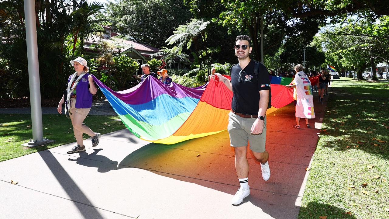 A small group of LGBTIQ people and supporters paraded along the Cairns Esplanade with a huge rainbow flag for the Pride Stride, part of the Cairns Pride Festival. Billie Stimpson and CJ lead the march away from Fogarty Park. Picture: Brendan Radke