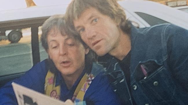 Beatles superfan Mark Baker with Sir Paul McCartney at Adelaide Airport in 1993. Picture: Supplied