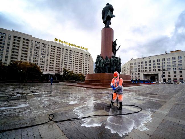 A municipal worker disinfects a square near Lenins monument in central Moscow. Picture: AFP