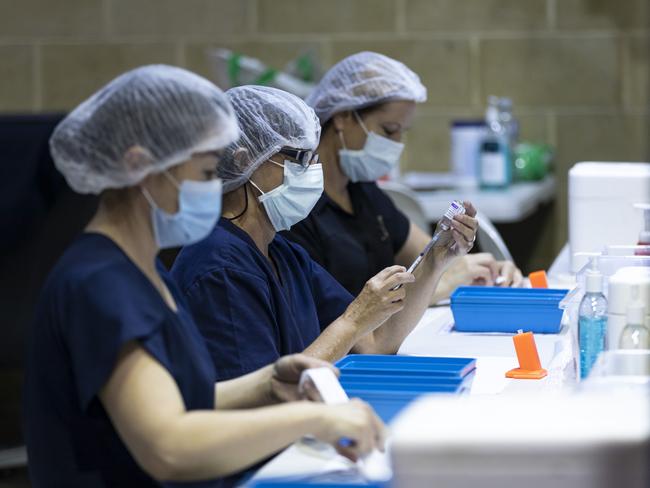 PERTH, AUSTRALIA - APRIL 28: Nurses are seen drawing up doses from a multi-dose vile of AstraZeneca Covid-19 vaccine at Claremont Showground on April 28, 2021 in Perth, Australia. The West Australian Government have opened up two new Vaccine Centres including one at Perth Airport. (Photo by Matt Jelonek/Getty Images)