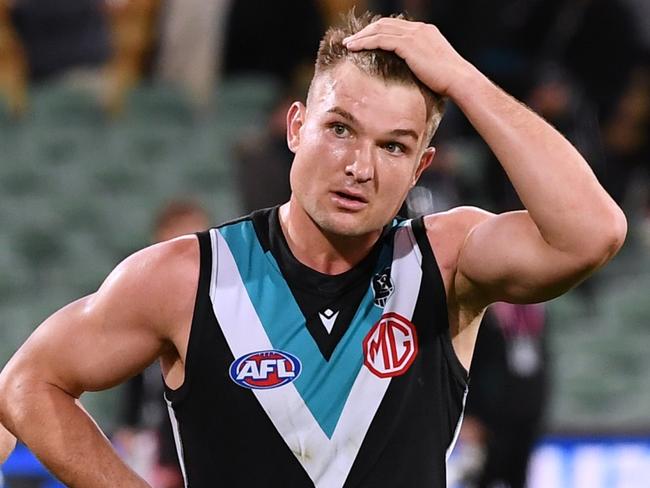 ADELAIDE, AUSTRALIA - JULY 08: Miles Bergman ,Ollie Wines and Darcy Byrne-Jones of Port Adelaide dejected after losing the round 17 AFL match between Port Adelaide Power and Melbourne Demons at Adelaide Oval on July 08, 2021 in Adelaide, Australia. (Photo by Mark Brake/Getty Images)