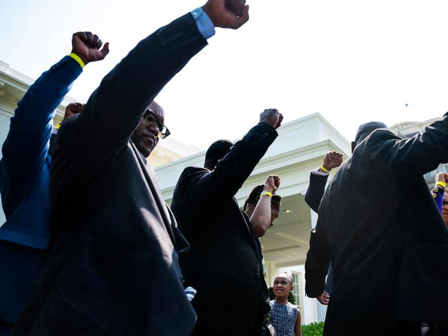 George Floyd family lawyer Ben Crump (R) holds up his fist with family members outside the White House. Picture: AFP