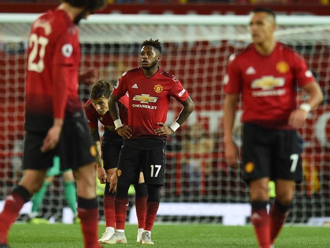 Manchester United's Brazilian midfielder Fred (C) reacts with team-mates after Tottenham's third goal during the English Premier League football match between Manchester United and Tottenham Hotspur at Old Trafford in Manchester, north west England, on August 27, 2018. (Photo by Oli SCARFF / AFP) / RESTRICTED TO EDITORIAL USE. No use with unauthorized audio, video, data, fixture lists, club/league logos or 'live' services. Online in-match use limited to 120 images. An additional 40 images may be used in extra time. No video emulation. Social media in-match use limited to 120 images. An additional 40 images may be used in extra time. No use in betting publications, games or single club/league/player publications. /