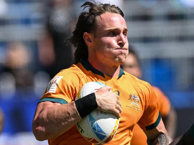 Australia's Corey Toole #3 evades Kenya's Daniel Taabu #1 to score a try during the rugby union match between Australia and Kenya on the second day of the Los Angeles 2022 World Rugby Sevens Series event at Dignity Health Sports Park in Carson, California, on August 28, 2022. (Photo by Patrick T. FALLON / AFP)