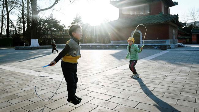 Children skip at a park in Beijing. Picture: Wang Zhao/AFP