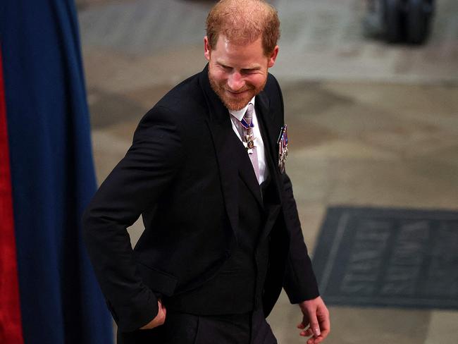 A smiling Prince Harry enters Westminster Abbey. Picture: AFP