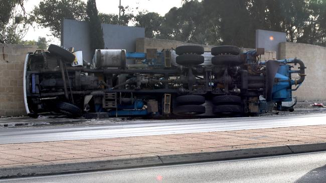 Despite the truck flipping on its side, the driver did not suffer life-threatening Picture: Dean Martin