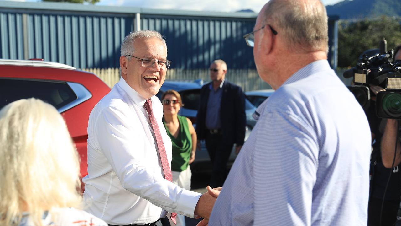 Prime Minister Scott Morrison shakes hands with Member for Leichhardt Warren Entsch at the Cairns and District Darts Association Hall. Picture: Brendan Radke