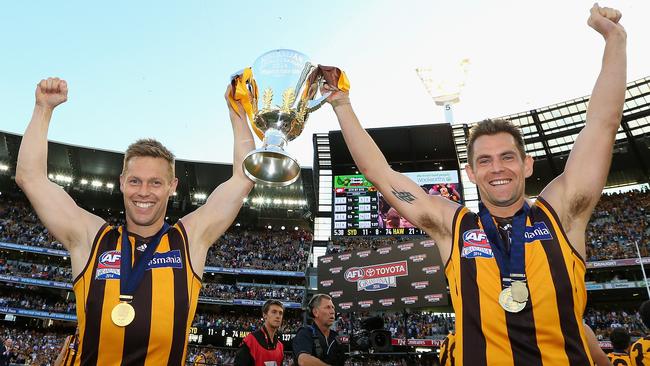 Sam Mitchell and Luke Hodge with the premiership cup in 2014.