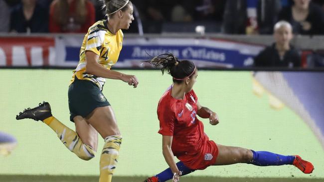 United States forward Alex Morgan scores and Alanna Kennedy can’t do anything about it. Picture: AP Photo/David Zalubowski