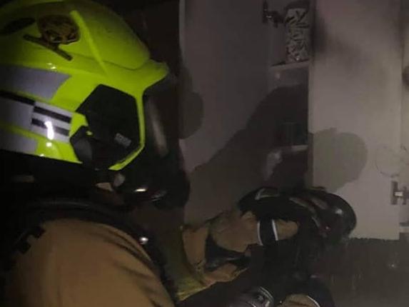 A Fire and Rescue NSW firefighter  from the Forestville brigade  puts out a fire in the kitchen of a home in Hurdis Ave, Frenchs Forest,that started in the oven. Picture: Fire and Rescue (Forestville)