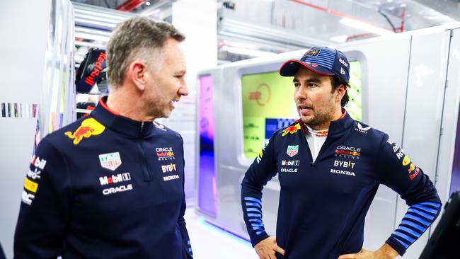 Red Bull Racing Team Principal Christian Horner (L) and Sergio Perez of Mexico and Oracle Red Bull Racing talk in the garage during practice. (Photo by Mark Thompson/Getty Images)