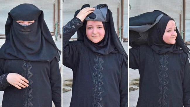 A girl rips off her burqa after she was evacuated from Manbij, an Islamic State-controlled neighbourhood of Manbij, Syria. Picture: The Times