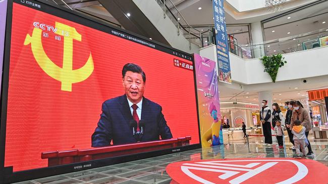 Shoppers watch a live broadcast of President Xi Jinping at a mall in Qingzhou in Shandong province. Picure: AFP