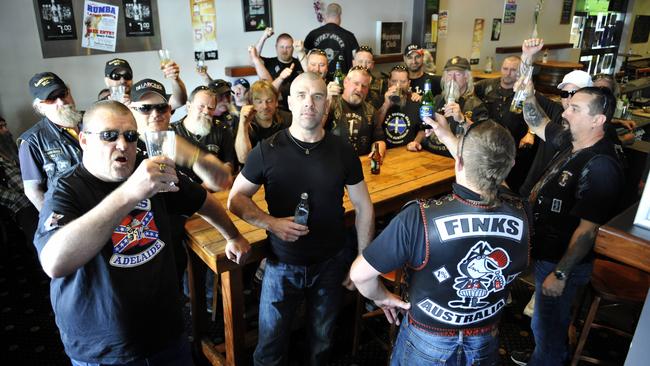 Members of various Adelaide motorcycle gangs including spokesman Mick McPherson, centre, celebrate after an anti-bikie law was defeated in the High Court in 2010.