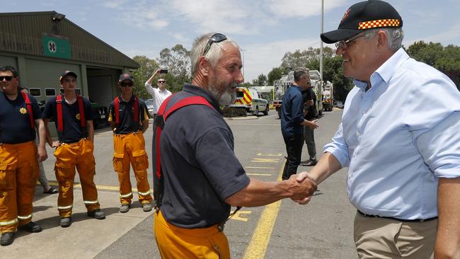 Prime Minister Scott Morrison meets crews from Woodside CFS in Woodside. He claims he was ‘blindsided’ by the QLD government’s refusal to take up the offer. (AAP Image/Kelly Barnes)