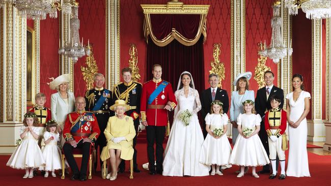 The bride and groom, centre, with their families on their wedding day. Picture: AP/Hugo Burnand/Clarence House