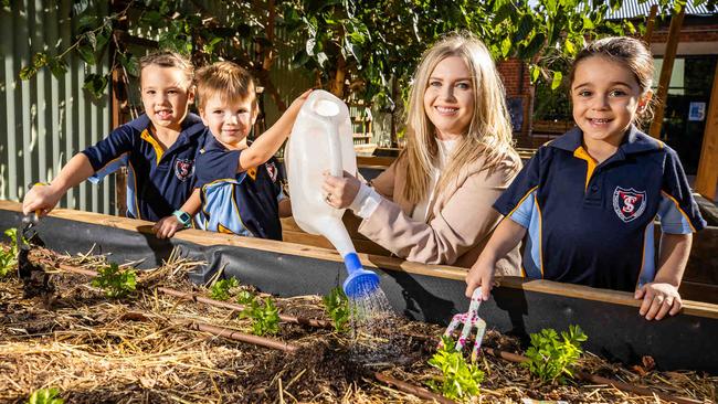 St Thomas Preschool teacher Emma Reardon with students Airlie, Ezekiel and Saddlie. Picture: Tom Huntley