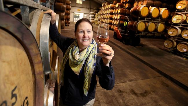 Cate Looney with a rose at Brown Brothers winery in Milawa, Victoria. Picture: David Geraghty