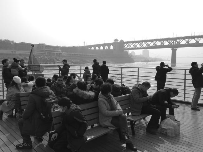 Chinese passengers on board Wuhan's ferry over the Yangtze River on January 20, 2020. Only a handful are wearing facemasks. Picture: Simon Carter