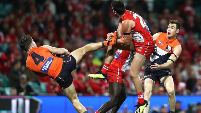 Toby Greene puts his foot out while marking.