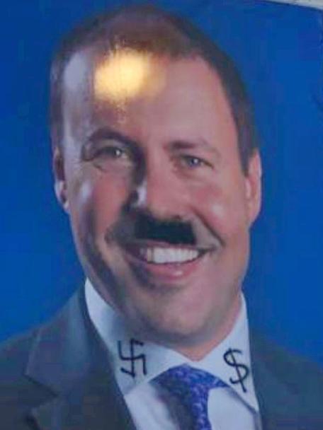 A Josh Frydenberg billboard defaced with Nazi symbolism.