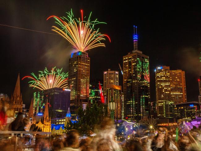 Revellers watch the New Year tick in with fireworks in Melbourne. Picture: Mark Stewart