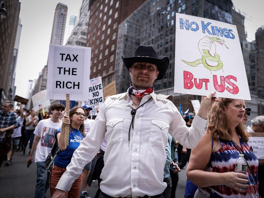 People hold up signs as they demonstrate during a rally titled “Protect Migrants, Protect the Planet” in New York City. Picture: AFP
