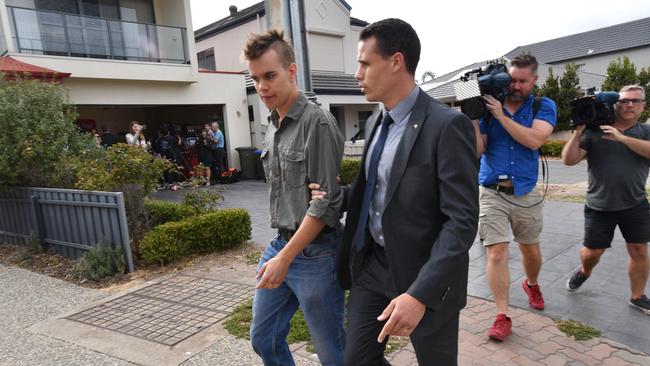 A protester is led away during a Jay Weatherill’s press conference at Henley Beach, today. Picture: AAP