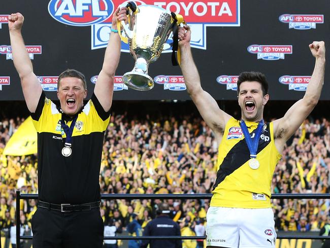 MELBOURNE, VICTORIA - SEPTEMBER 30:  Tigers head coach Damien Hardwick and Trent Cotchin of the Tigers lift up the Premiership Cup after winning during the 2017 AFL Grand Final match between the Adelaide Crows and the Richmond Tigers at Melbourne Cricket Ground on September 30, 2017 in Melbourne, Australia.  (Photo by Michael Dodge/AFL Media/Getty Images)