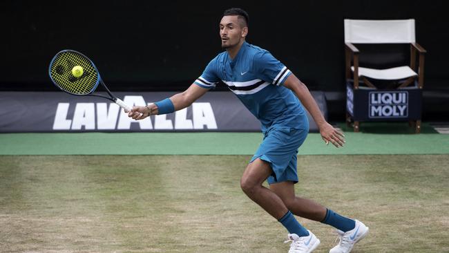 Nick Kyrgios returns a ball during his semi-final with Roger Federer. Picture: AP.