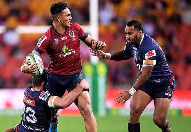 Jordan Petaia of the Reds looks to offload.