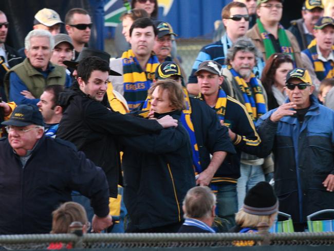 Eagle's footballer Leigh Treeby grapples with Luke Grant at Woodville Oval in 2010.