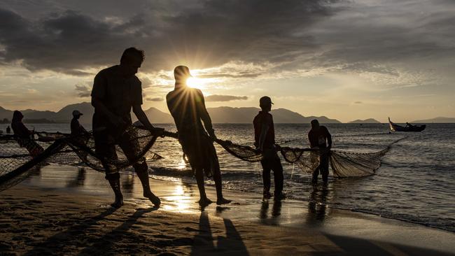 A group of fishermen pull fishing nets at Gampong Jawa beach in Aceh province, Indonesia. Forecasts say Indonesia will be the world’s 10th-largest economy by 2039. Picture: Getty Images