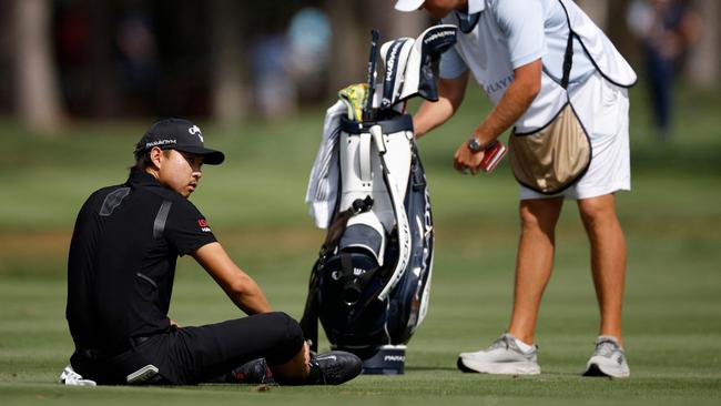 Lee holds his calf on the 15th fairway. Picture: Jared C. Tilton/Getty Images/AFP