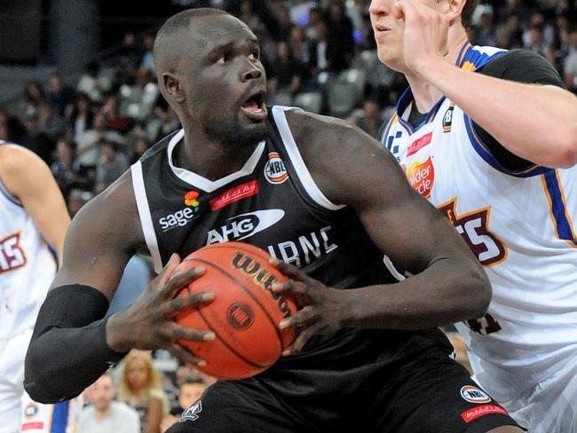 Majok Majok of Melbourne United is blocked by Cameron Bairstow of the Bullets, during the round 3 NBL match between Melbourne United and Brisbane Bullets, played at Hisense Arena in Melbourne, Thursday, Oct. 20, 2016. (AAP Image/Joe Castro) NO ARCHIVING, EDITORIAL USE ONLY
