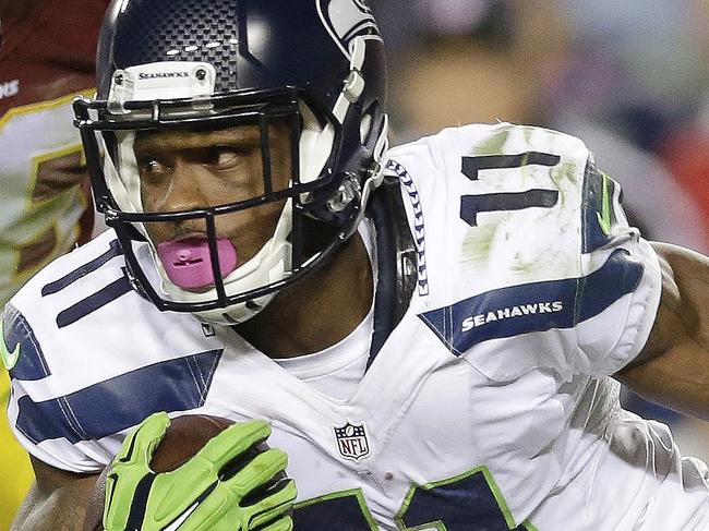 Seattle Seahawks wide receiver Percy Harvin (11) carries the ball past Washington Redskins inside linebacker Perry Riley (56) during the first half of an NFL football game in Landover, Md., Monday, Oct. 6, 2014. (AP Photo/Patrick Semansky)