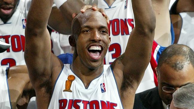 Chauncey Billups celebrates with the MVP trophy after the Detroit Pistons won the 2004 NBA finals.