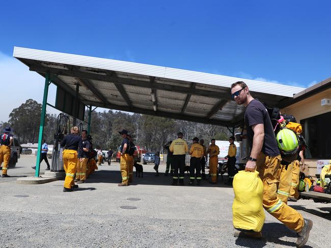 Personnel from the ACT Rural Fire Service head out from The Great Lakes store to the fire front near Miena. Picture: LUKE BOWDEN