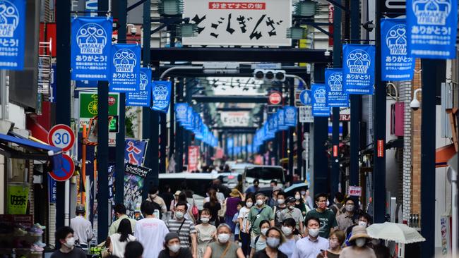 People wearing face masks as a preventive measure against the COVID-19 coronavirus visit Togoshi Ginza shopping street in Tokyo. Picture: AFP