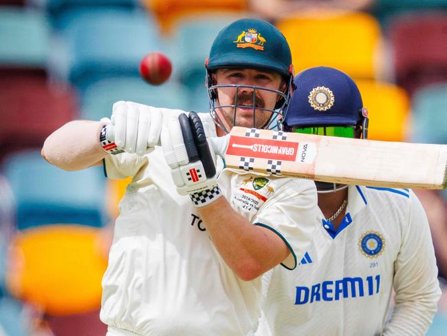 Australia's Travis Head hits a shot on day two of the third cricket Test match between Australia and India at The Gabba in Brisbane on December 15, 2024. (Photo by Patrick HAMILTON / AFP) / -- IMAGE RESTRICTED TO EDITORIAL USE - STRICTLY NO COMMERCIAL USE --