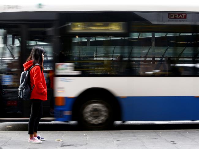 A commuter at Railway Square waits for the right service as Buses from the Inner West rush past.The First day of Private Company Transit Systems , taking over Region 6,  the Inner West Bus run,  from Transport NSW. Picture: John Appleyard