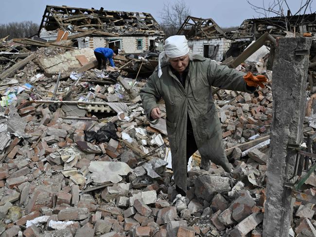 Svitlana Zavaly, 67, walks over the rubble of her house destroyed by a Russian bomb in the village Velyka Pysarivka, which lies just five kilometres from the Russian border. Picture: AFP