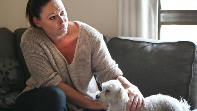 Rachael and her dog Pippie at home recovering. Picture: Glenn Hampson