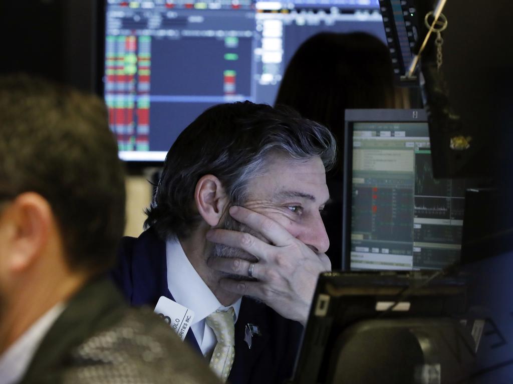 Trader John Romolo works on the floor of the New York Stock Exchange. Stocks went into a steep slide Thursday after Apple sent a shudder through Wall Street with word that iPhone sales in China are falling. Picture: AP