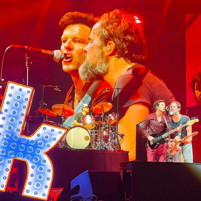 Tim McClelland playing drums on The Killers Song ‘For Reasons Unknown’ with frontman Brandon Flowers and Ronnie Vannucci Jr who switched to guitar. Picture: Cameron Bates