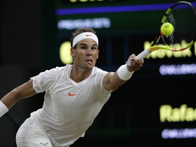 Rafael Nadal of Spain returns a ball to Novak Djokovic